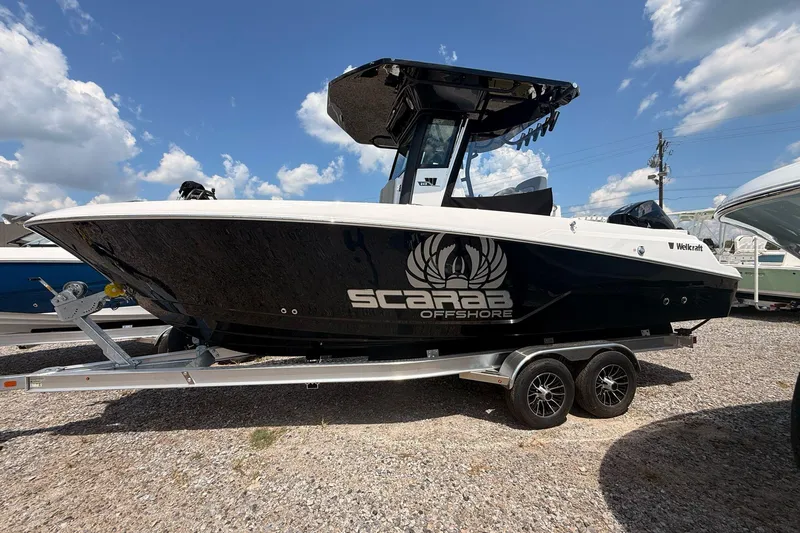 Slide: The Image of 2026 Wellcraft 243 Fisherman boat on trailer under blue sky. - 2