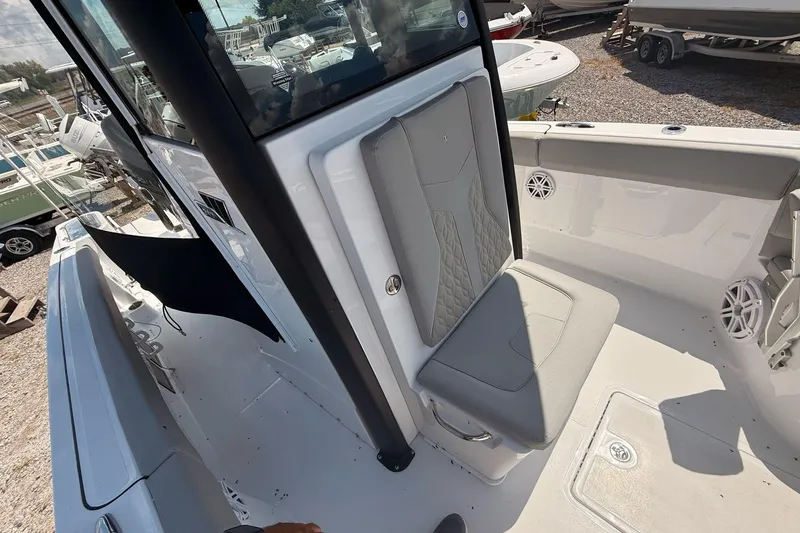 Slide: The Image of 2026 Wellcraft 243 Fisherman boat interior with cushioned seating and storage. - 23