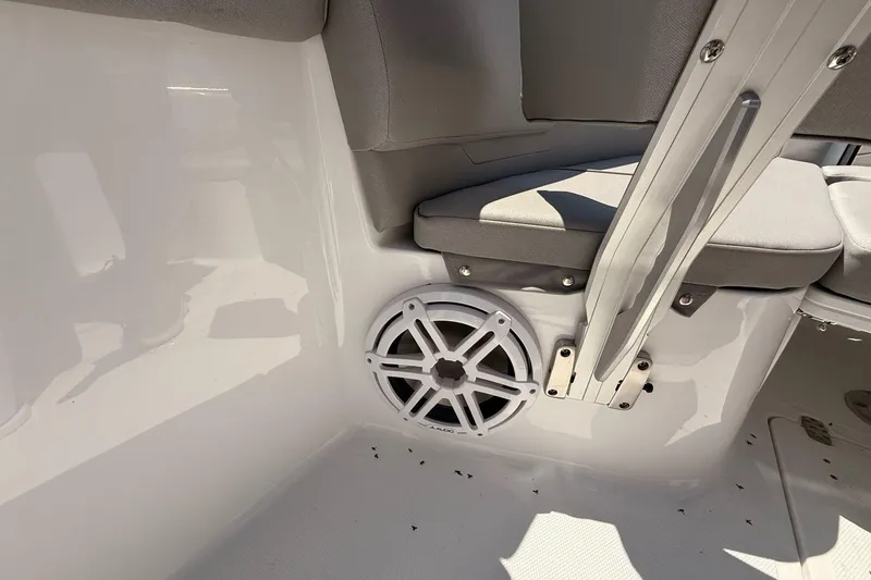 Slide: The Image of 2026 Wellcraft 243 Fisherman boat interior with speaker and cushioned seating. - 24