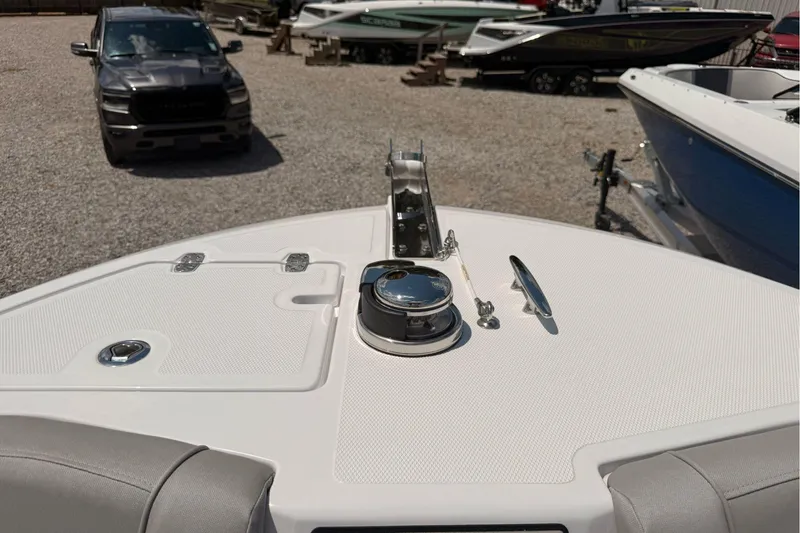 Slide: The Image of Bow view of 2026 Wellcraft 243 Fisherman boat in a gravel lot. - 27