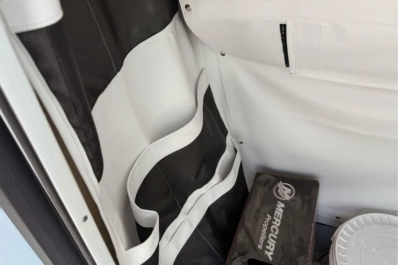 Slide: The Image of Interior storage of 2026 Wellcraft 243 Fisherman boat with Mercury propellers box. - 30