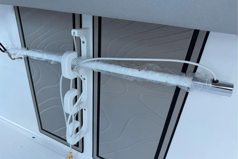 Slide: The Image of 2026 Wellcraft 243 Fisherman boat interior detail with mounted rod holder. - 37