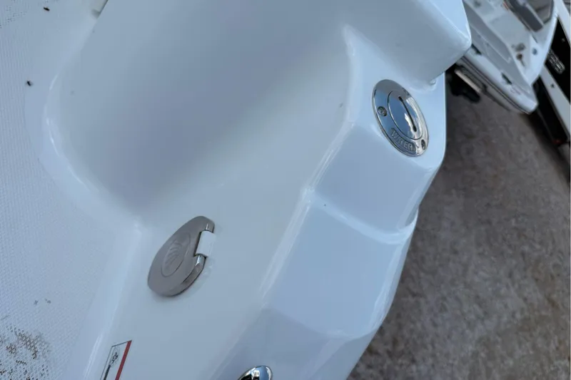 Slide: The Image of 2026 Wellcraft 243 Fisherman boat fuel and water cap details. - 42