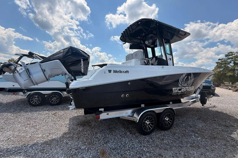 Slide: The Image of 2026 Wellcraft 243 Fisherman boat on trailer, featuring sleek design and powerful Mercury engine. - 5