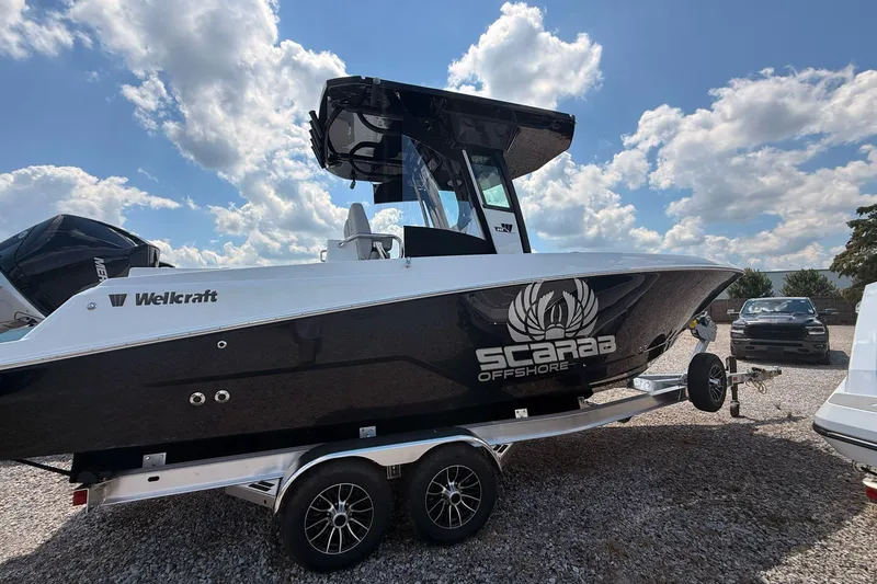 Slide: The Image of 2026 Wellcraft 243 Fisherman boat on trailer under blue sky. - 6
