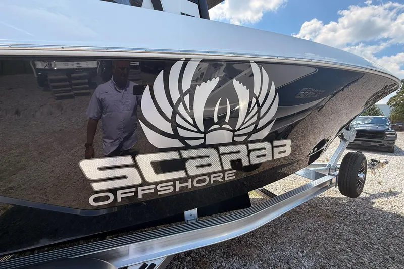 Slide: The Image of 2026 Wellcraft 243 Fisherman boat with Scarab Offshore branding on trailer. - 7