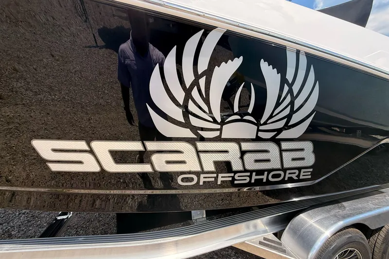 Slide: The Image of 2026 Wellcraft 243 Fisherman boat with Scarab Offshore logo on black hull. - 9