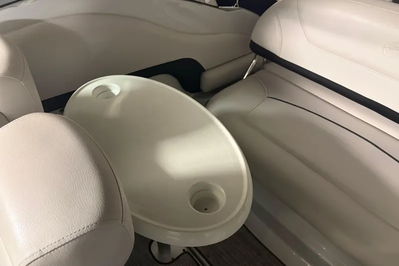 Slide: The Image of 2021 Crownline 264 CR boat interior with beige seating and oval table. - 13