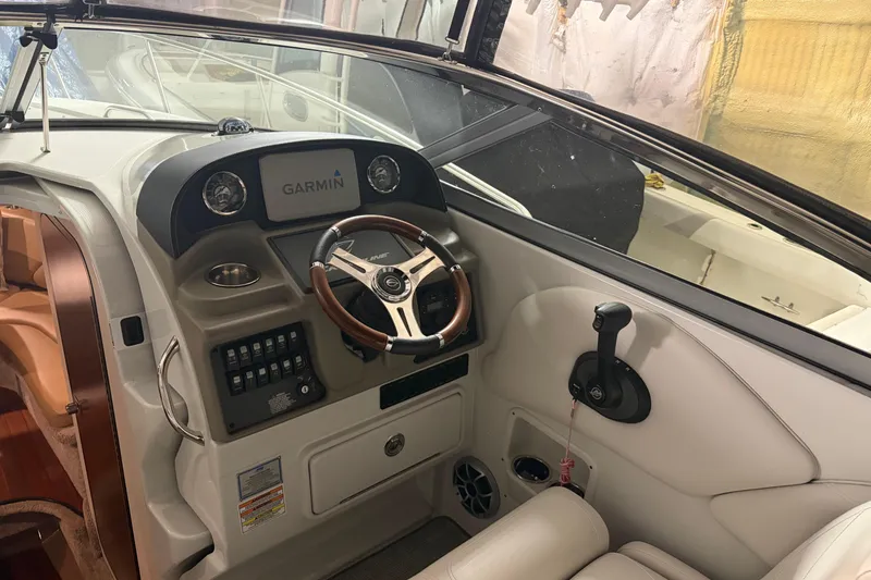 Slide: The Image of 2021 Crownline 264 CR boat cockpit with Garmin navigation system and steering wheel. - 20
