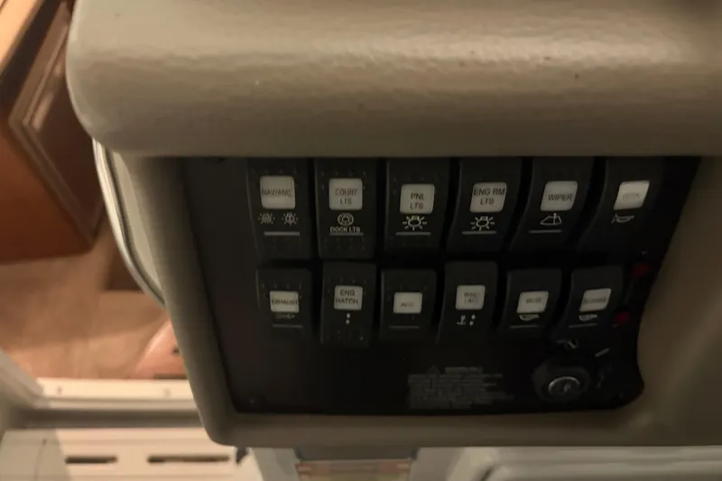 Slide: The Image of Control panel of a 2021 Crownline 264 CR boat with labeled switches. - 21