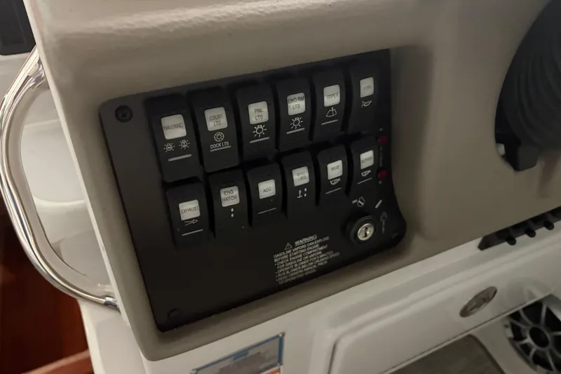 Slide: The Image of Control panel of a 2021 Crownline 264 CR boat with labeled switches. - 25