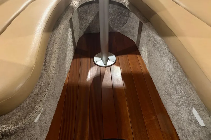 Slide: The Image of 2021 Crownline 264 CR interior with plush seating and wooden flooring. - 27