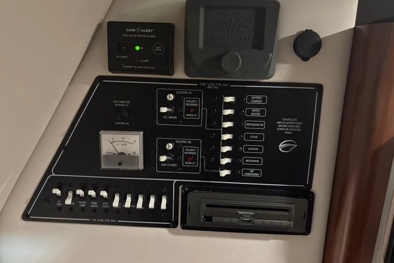Slide: The Image of Control panel of a 2021 Crownline 264 CR boat with various switches and indicators. - 29