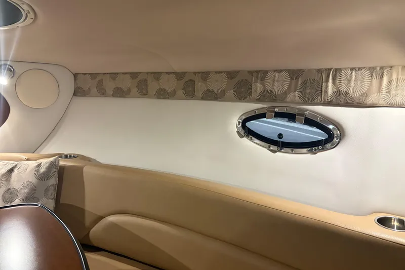 Slide: The Image of Interior of 2021 Crownline 264 CR boat with elegant seating and porthole window. - 30