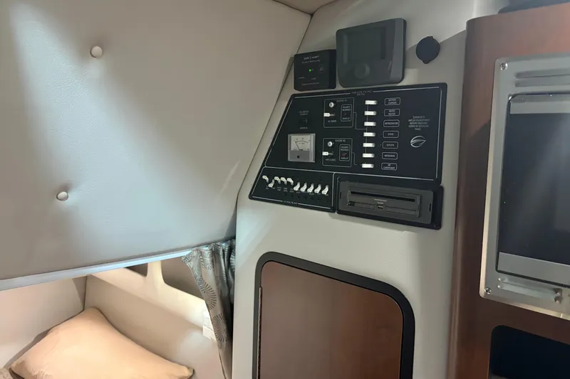 Slide: The Image of 2021 Crownline 264 CR cabin interior with control panel and cozy sleeping area. - 33