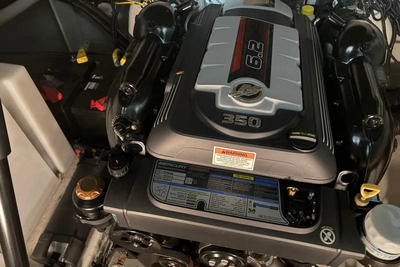 Slide: The Image of Engine compartment of a 2021 Crownline 264 CR boat, featuring a Mercury 6.2L engine. - 35