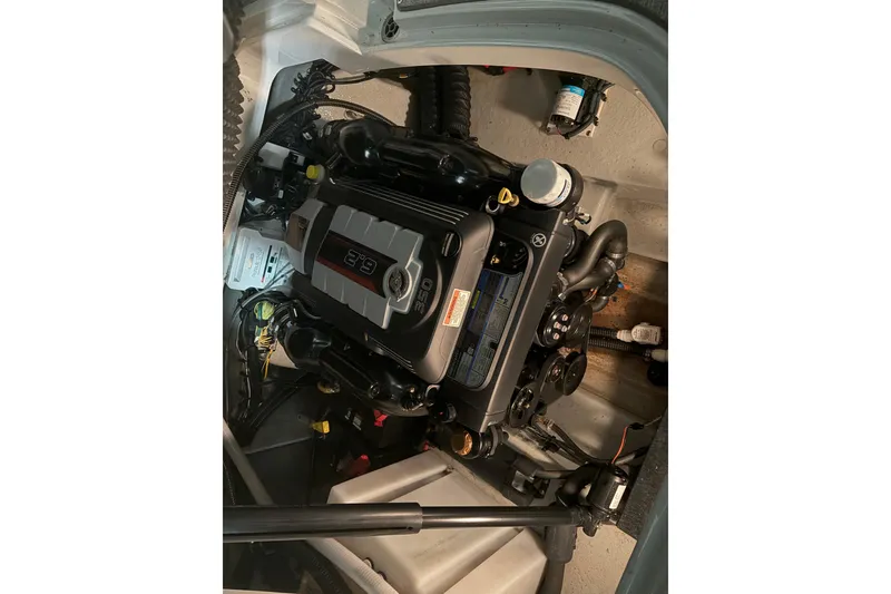 Slide: The Image of Engine compartment of a 2021 Crownline 264 CR boat, showcasing the powerful engine. - 37