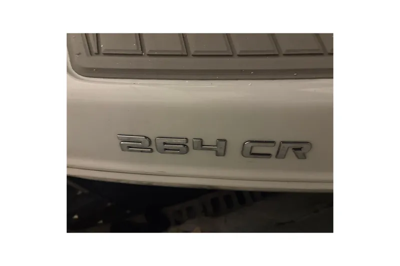 Slide: The Image of 2021 Crownline 264 CR boat emblem on white surface. - 39