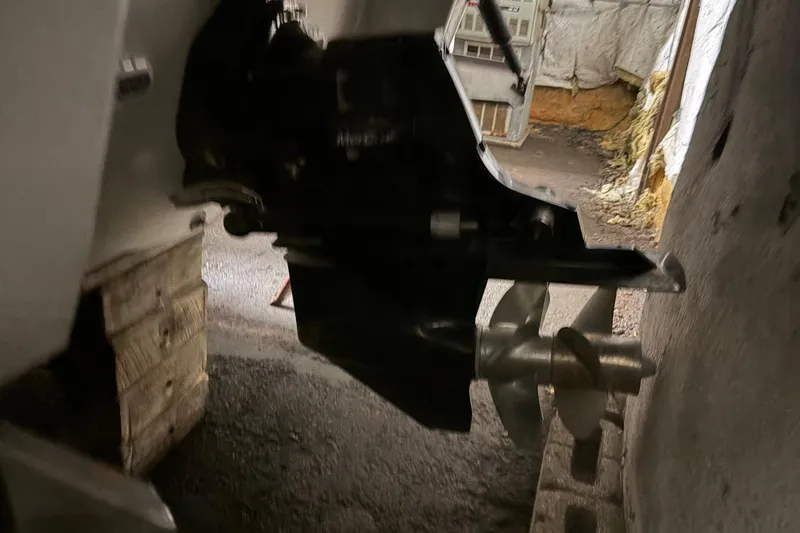 Slide: The Image of 2021 Crownline 264 CR boat propeller and drive system in a storage area. - 40
