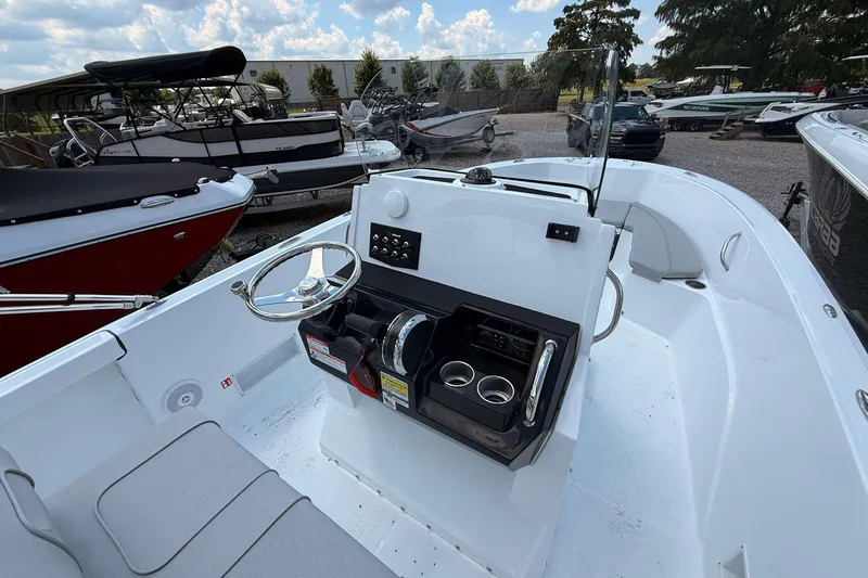 Slide: The Image of 2026 Wellcraft 202 Fisherman boat interior with steering console and seating area. - 10