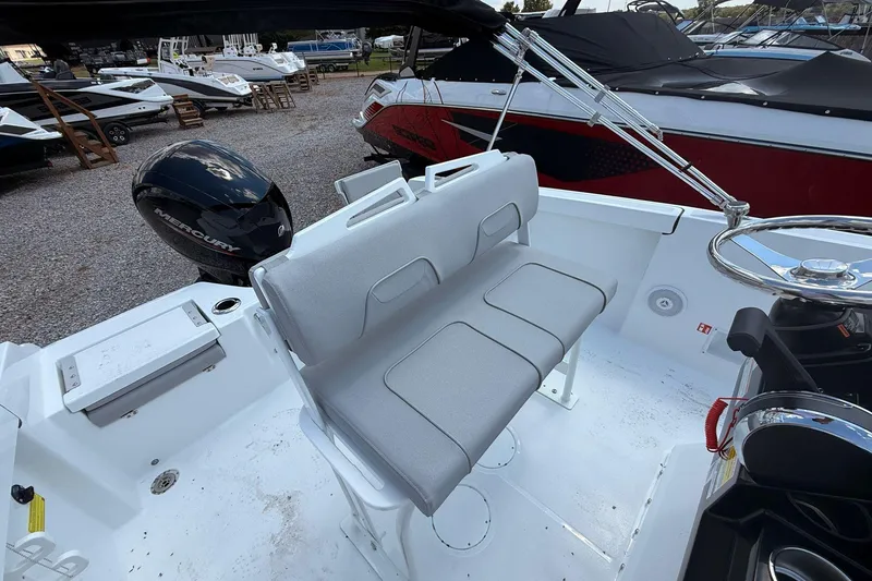 Slide: The Image of 2026 Wellcraft 202 Fisherman boat interior with seating and Mercury engine. - 11