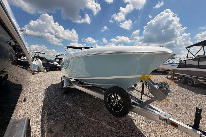 Slide: The Image of 2026 Wellcraft 202 Fisherman boat on trailer under a bright blue sky. - 2