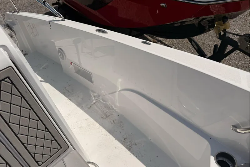 Slide: The Image of 2026 Wellcraft 202 Fisherman boat interior, featuring clean white deck and seating area. - 21