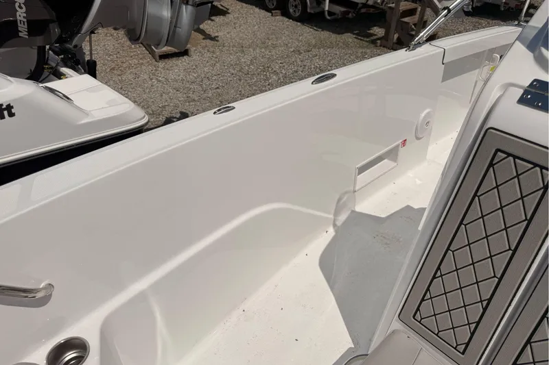 Slide: The Image of 2026 Wellcraft 202 Fisherman boat interior with clean white deck and engine view. - 22