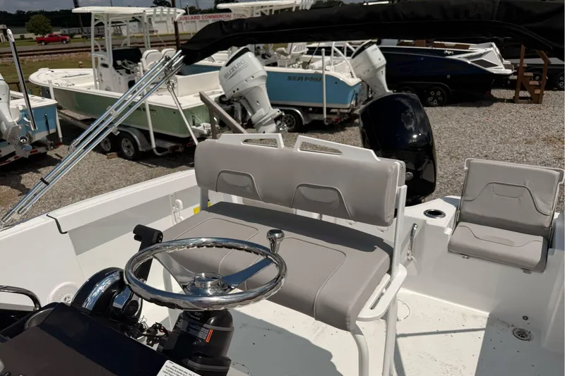 Slide: The Image of 2026 Wellcraft 202 Fisherman boat interior with steering wheel and seating. - 23