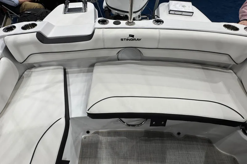 Slide: The Image of 2026 Stingray 191 DC boat interior with white seating and cup holders. - 17