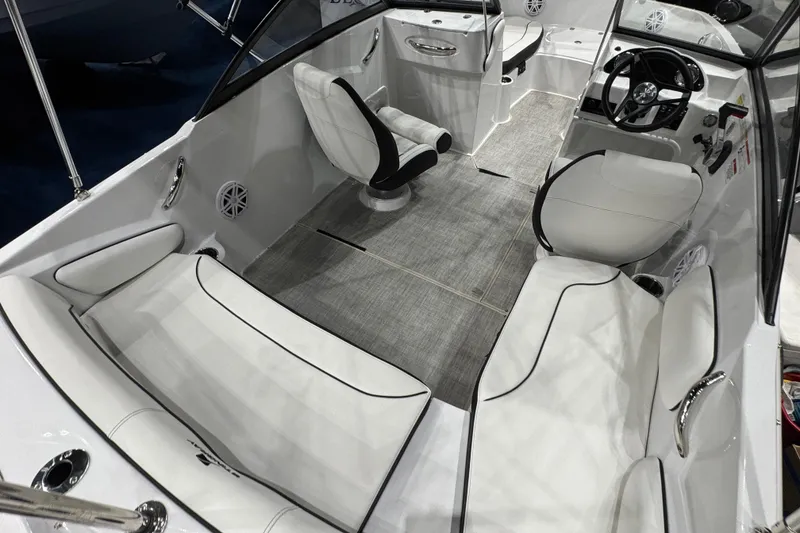 Slide: The Image of 2026 Stingray 191 DC boat interior with white seating and modern dashboard. - 5