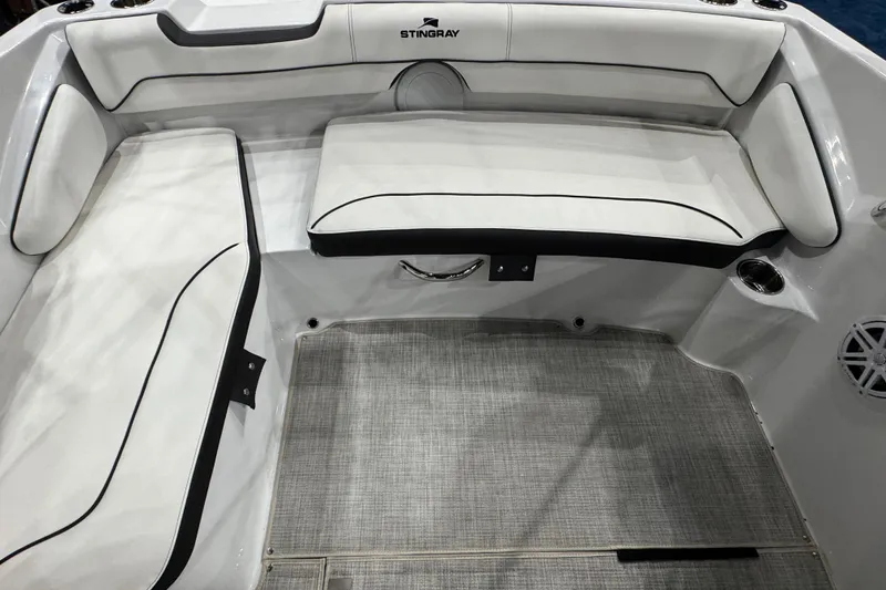 Slide: The Image of 2026 Stingray 191 DC boat interior with white cushioned seating and gray flooring. - 6