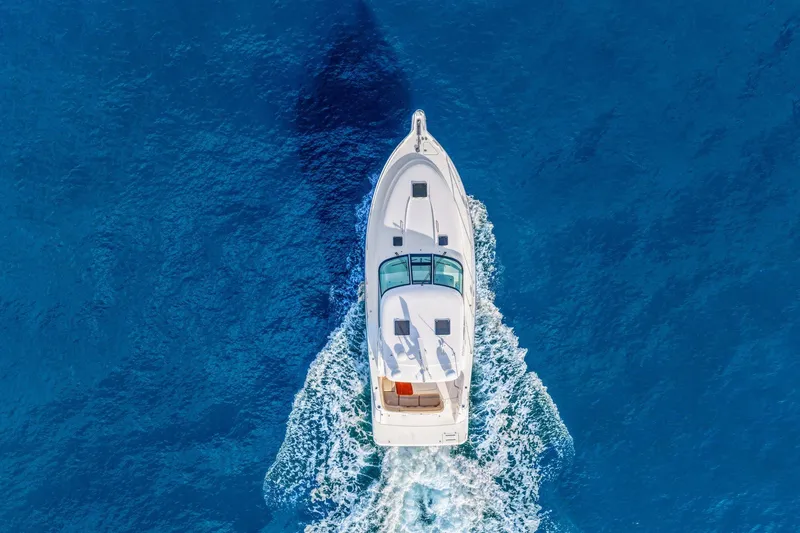 Slide: The Image of Aerial view of 2008 Tiara Yachts 4300 Sovran cruising on vibrant blue ocean. - 10