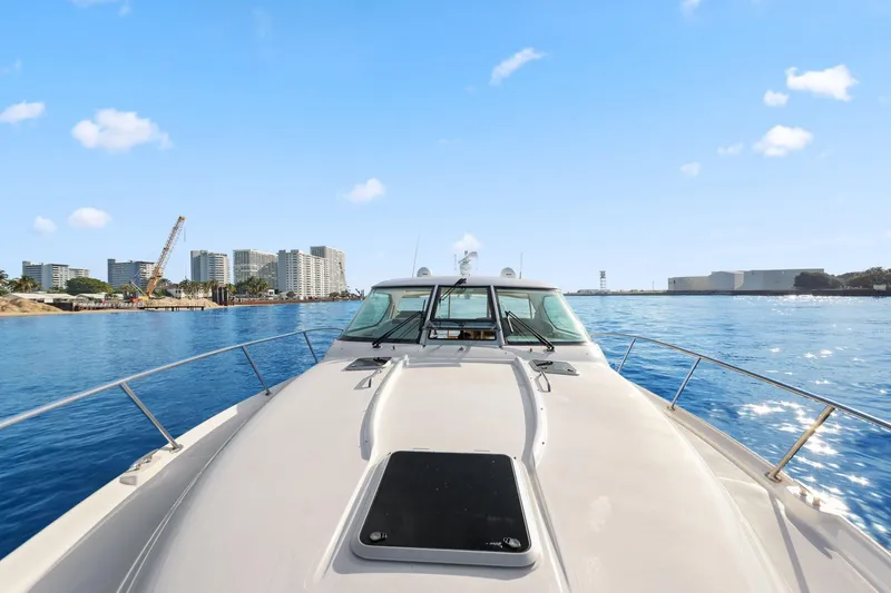 Slide: The Image of 2008 Tiara Yachts 4300 Sovran cruising near city skyline on a sunny day. - 11