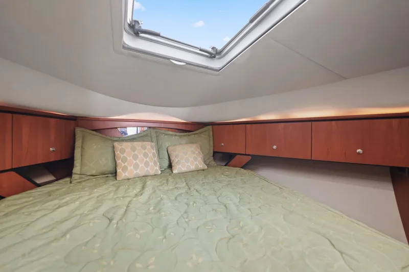 Slide: The Image of Luxurious cabin interior of 2008 Tiara Yachts 4300 Sovran with skylight and elegant bedding. - 22