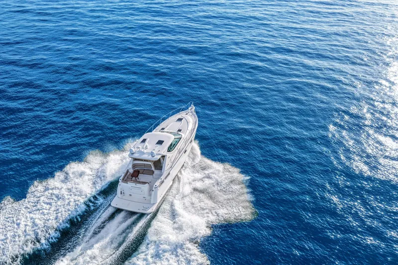 Slide: The Image of 2008 Tiara Yachts 4300 Sovran cruising on open blue ocean waters. - 6