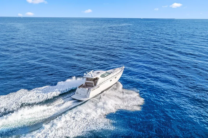 Slide: The Image of 2008 Tiara Yachts 4300 Sovran cruising on open blue ocean waters. - 7