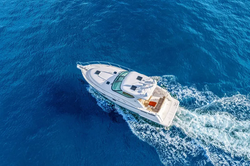 Slide: The Image of Aerial view of 2008 Tiara Yachts 4300 Sovran cruising on blue ocean waters. - 9
