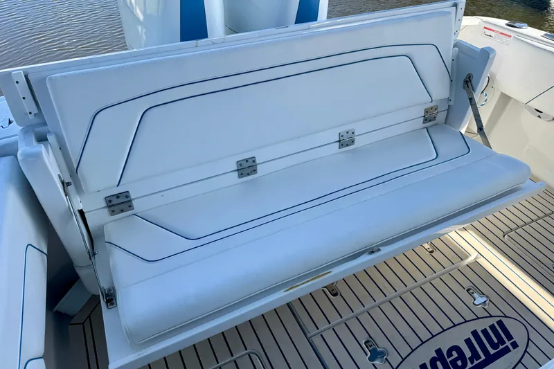 Slide: The Image of 2025 Intrepid 327 Cuddy boat with foldable white seating and teak deck. - 12