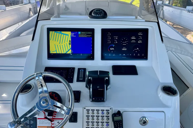 Slide: The Image of 2025 Intrepid 327 Cuddy helm with dual displays and modern controls. - 14