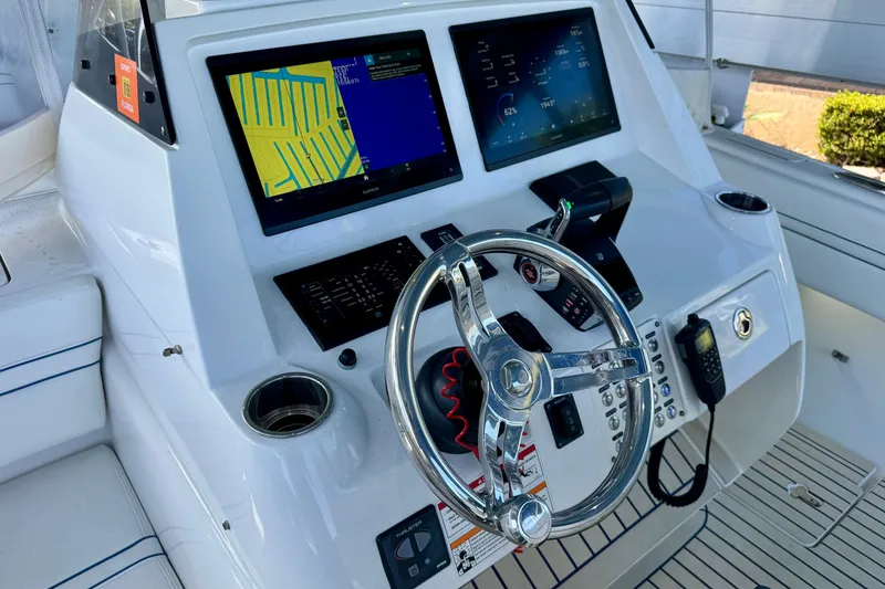 Slide: The Image of 2025 Intrepid 327 Cuddy helm with dual displays and modern controls. - 15