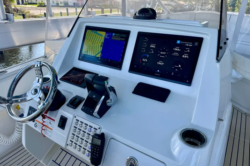 Slide: The Image of Intrepid 327 Cuddy 2025 boat dashboard with navigation screens and controls. - 17