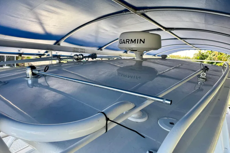 Slide: The Image of 2025 Intrepid 327 Cuddy boat roof with Garmin radar under canopy. - 18