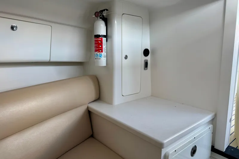 Slide: The Image of Interior of 2025 Intrepid 327 Cuddy featuring seating, storage, and a fire extinguisher. - 21