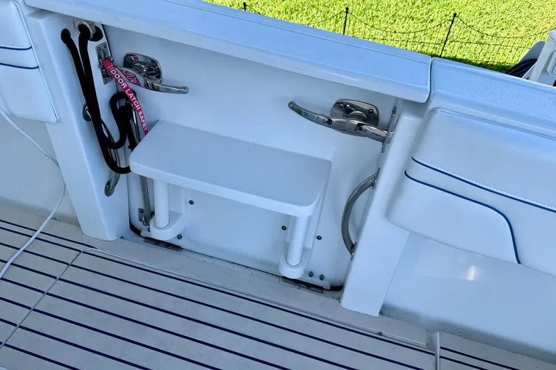 Slide: The Image of 2025 Intrepid 327 Cuddy boat deck with step and safety latch. - 24