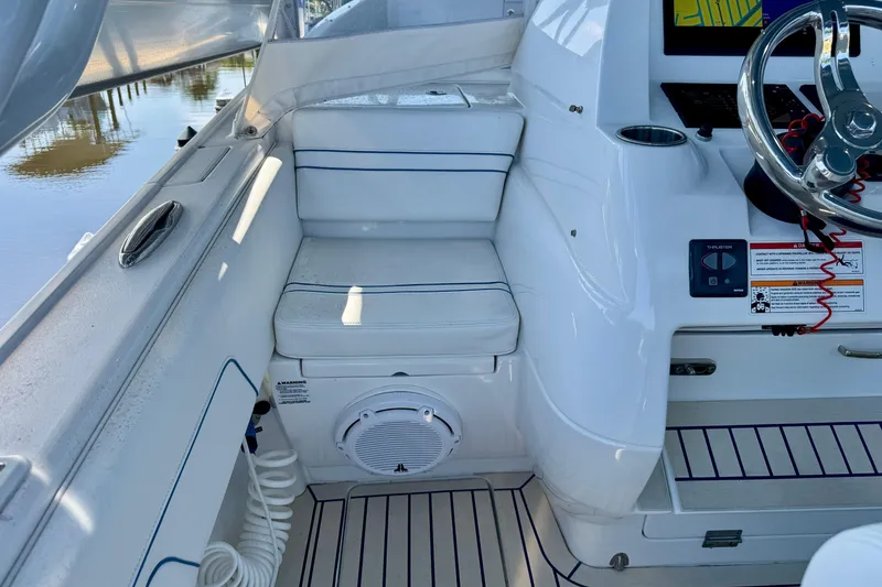 Slide: The Image of 2025 Intrepid 327 Cuddy boat interior with seating and steering wheel. - 28