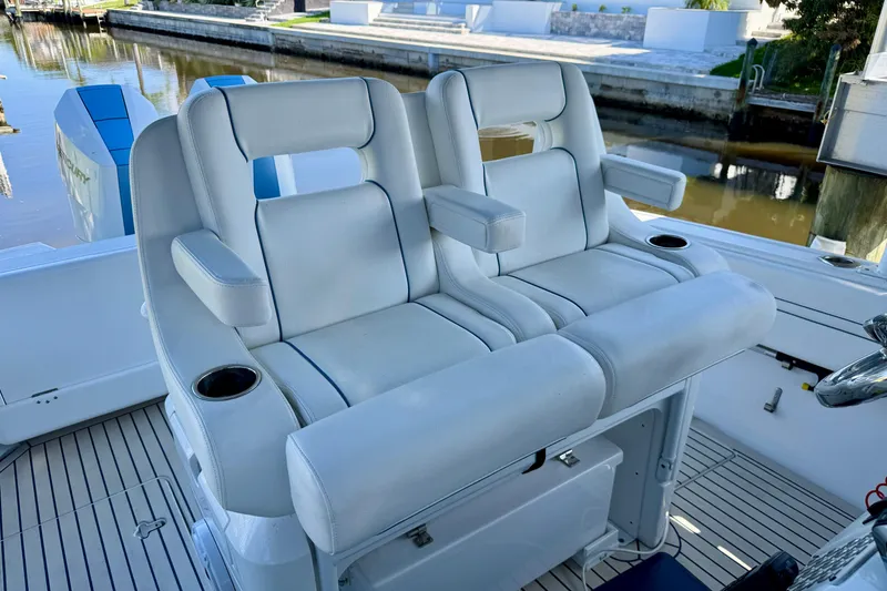 Slide: The Image of Luxury seating on 2025 Intrepid 327 Cuddy boat, featuring comfortable armrests and cup holders. - 31