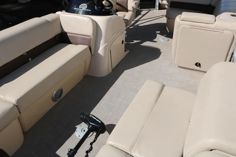 Slide: The Image of 2019 Sun Tracker SportFish 22 XP3 interior with beige seating and steering console. - 19