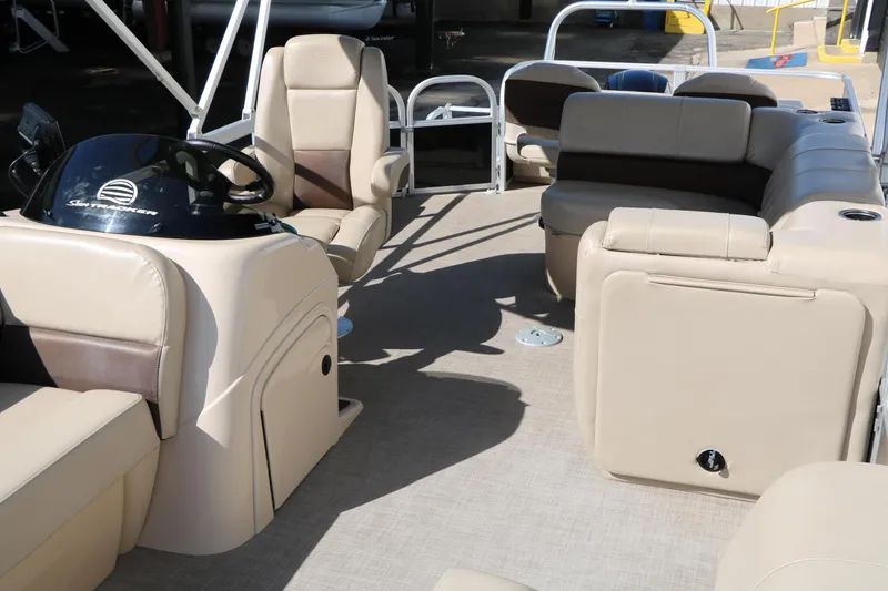 Slide: The Image of 2019 Sun Tracker SportFish 22 XP3 interior with beige seating and steering console. - 20