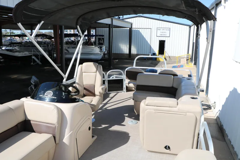 Slide: The Image of 2019 Sun Tracker SportFish 22 XP3 pontoon boat interior with seating and canopy. - 21